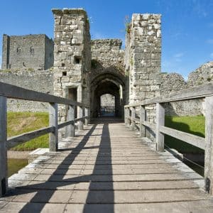Portchester,Castle,In,Hampshire,Viewed,Over,A,Wooden,Bridge,On