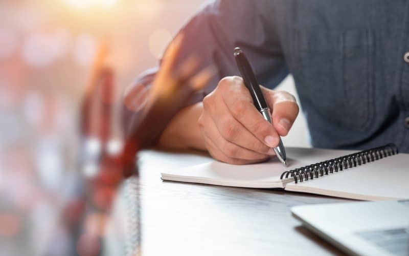 Close up,Of,Man,Hand,Using,Writing,Pen,Memo,On,Notebook