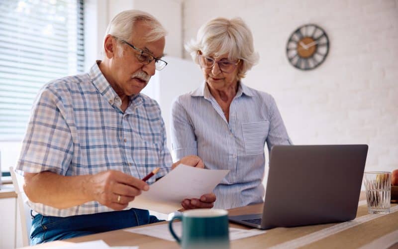 Senior,Couple,Planning,Their,Household,Budget,At,Home.,Focus,Is
