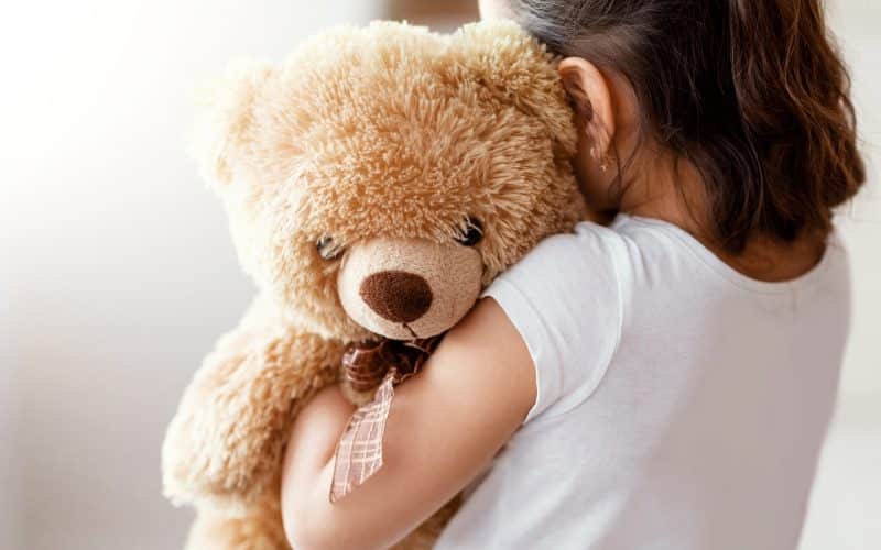 Unrecognizable,Kid,Girl,Embracing,Teddy,Bear,Toy,Standing,Alone,Near
